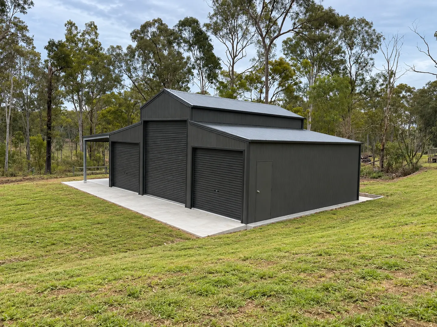 Rear view of a steel shed built into a sloping rural block