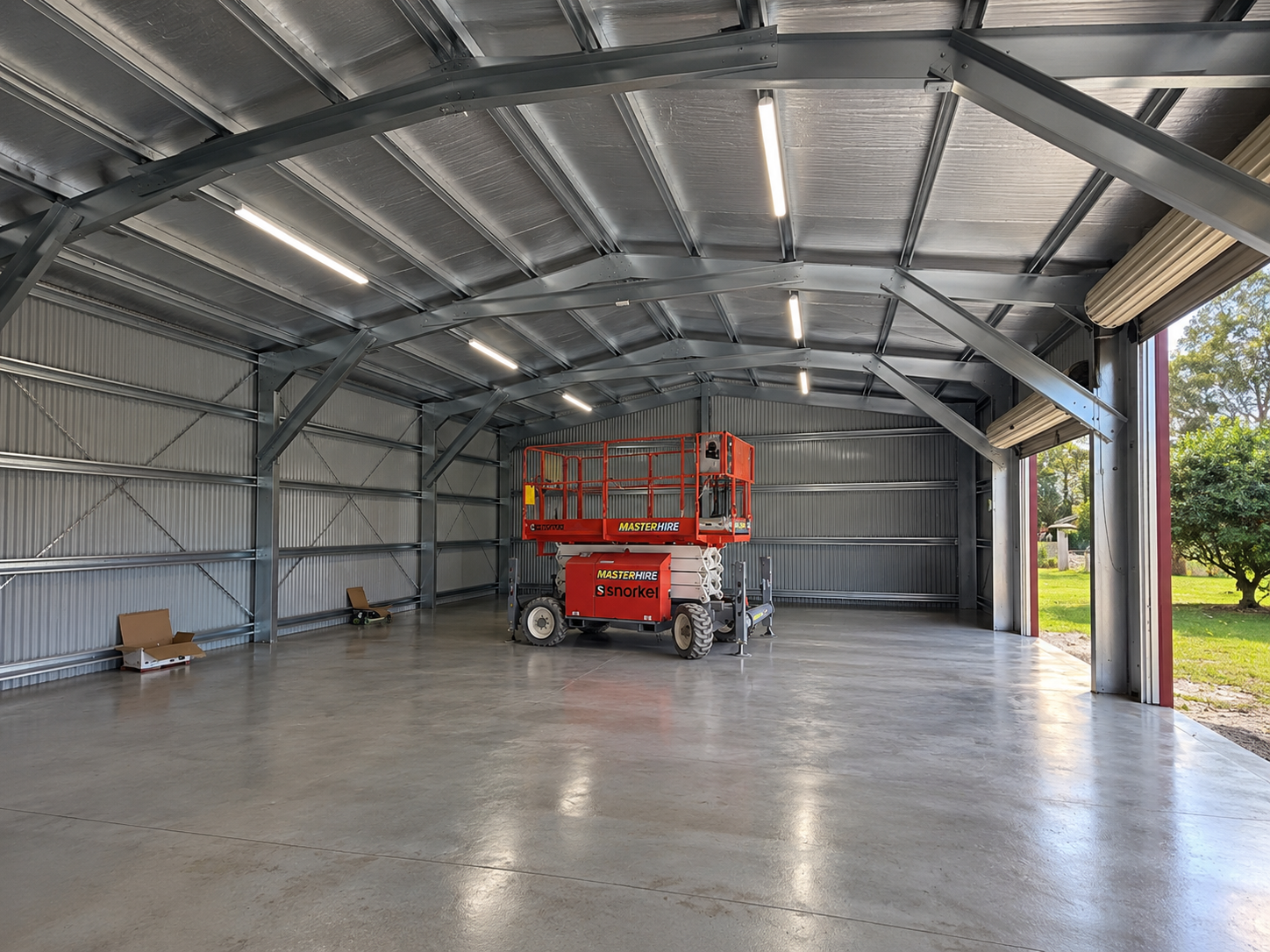 Clear-span steel frame interior of a workshop shed with sealed concrete floor, Tamborine