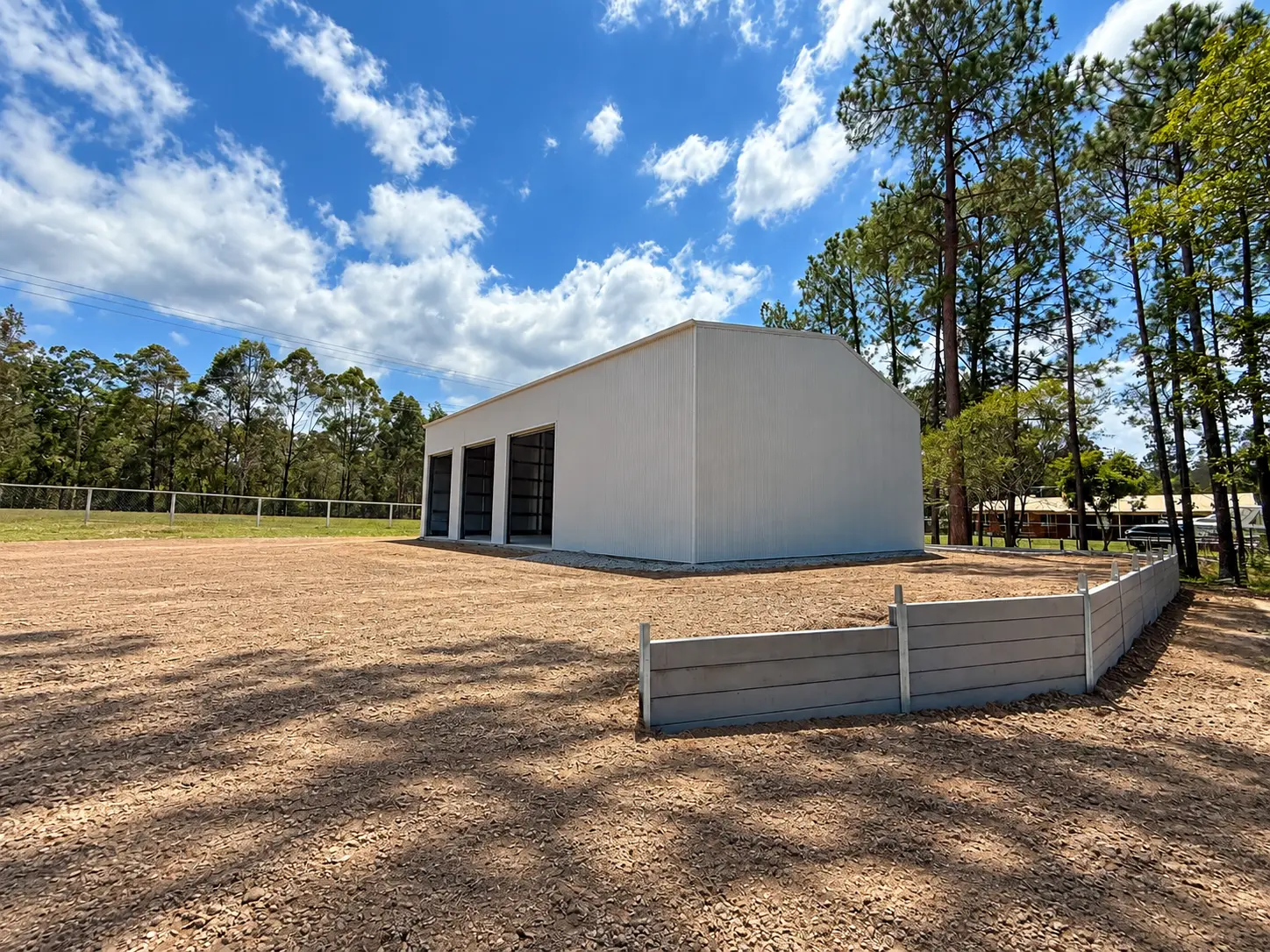 Rear corner view of a large white Colorbond commercial shed, Morayfield