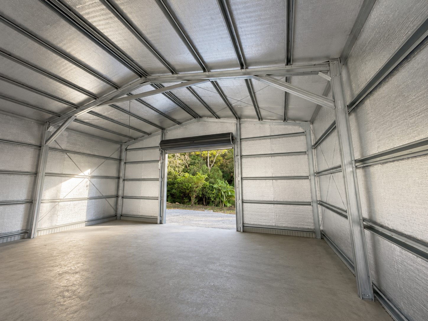 Interior view of a steel garage with space for a vehicle and storage