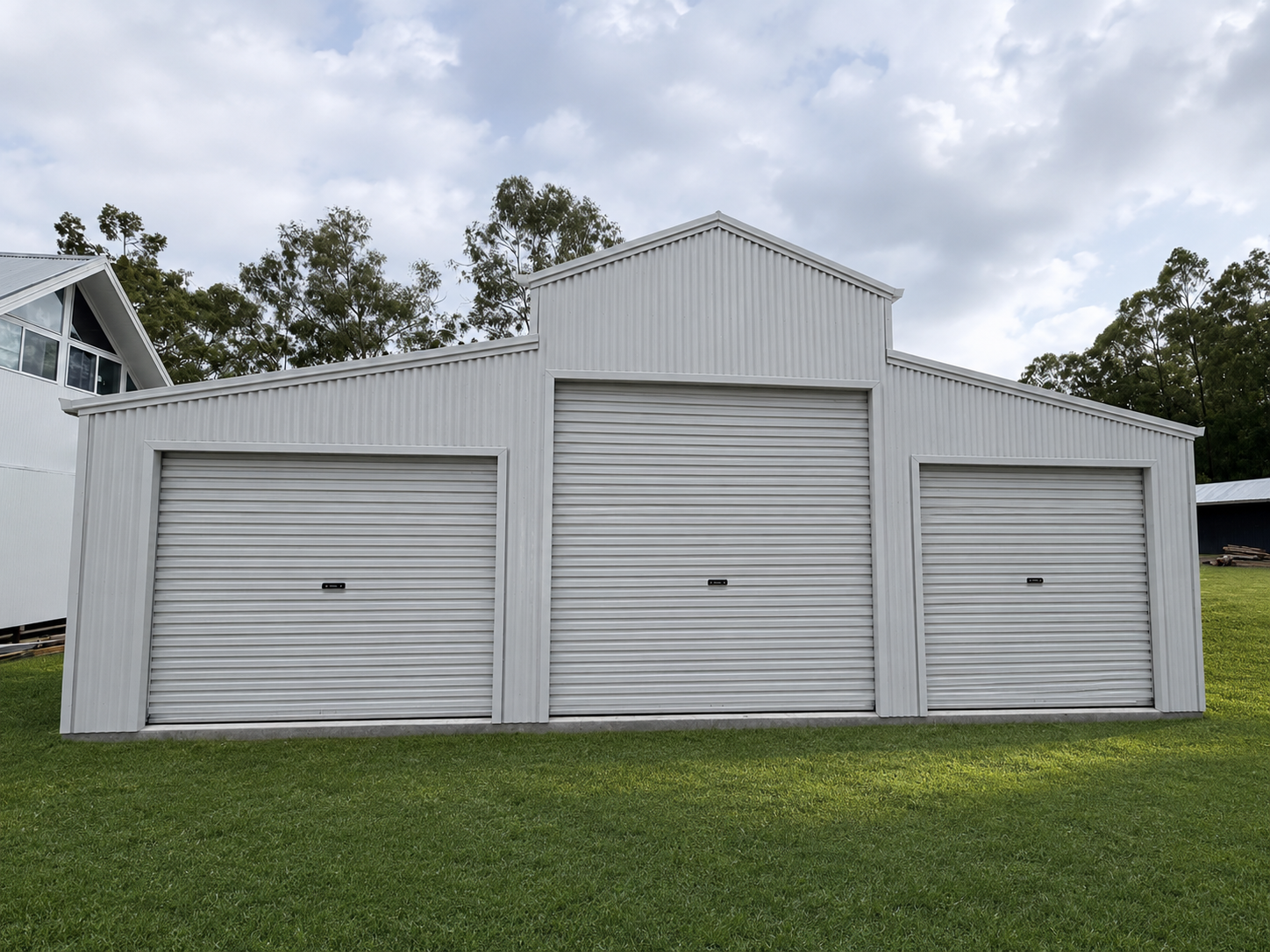 Completed steel shed with roller doors on a rural Queensland property
